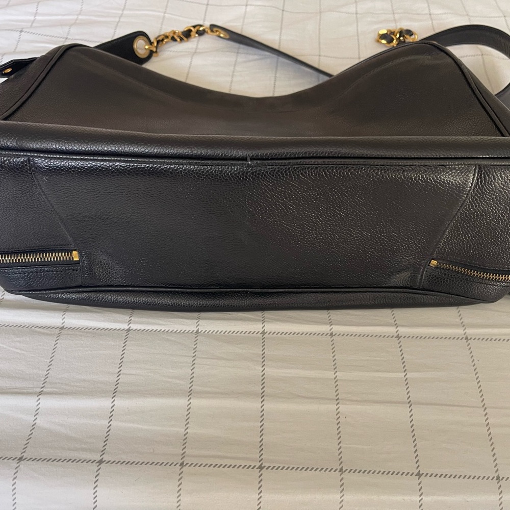 Chanel black leather bag with gold chain handle.There is a small cut on lock tag